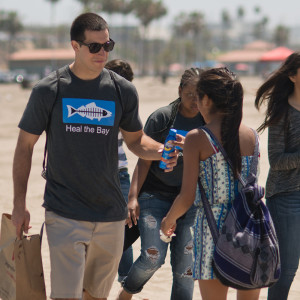 LMU student and high school student volunteering on beach clean up day.