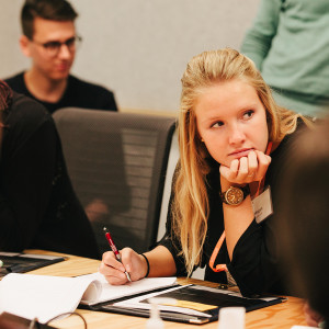 Female student taking notes during a Career Trek meeting.