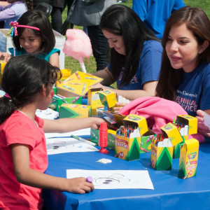 LMU students color with children during the Centennial Service Day.